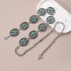 Detail of bohemian silver chain belt featuring turquoise stone floral metal carvings