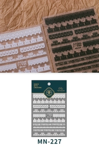 Detail of 5D thin lace nail stickers in black and white with vintage floral patterns