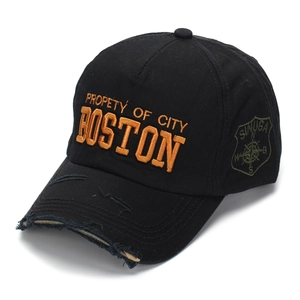 Close-up of distressed brim and yellow 3D embroidery on black cotton baseball cap
