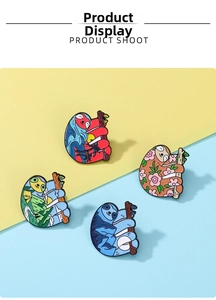 Detail view of four creative sloth enamel pins with colorful nature landscapes