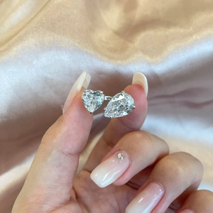 Detail of S925 sterling silver ring featuring heart and pear cut pink cubic zirconia