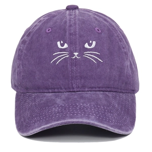 Close-up of purple washed cotton baseball cap featuring minimalist cat face embroidery