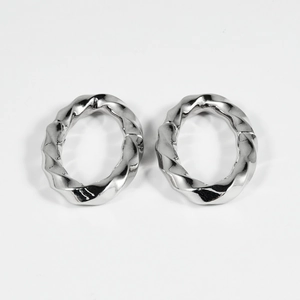 Detailed view of large oval silver earrings with twisted rope texture and polished finish