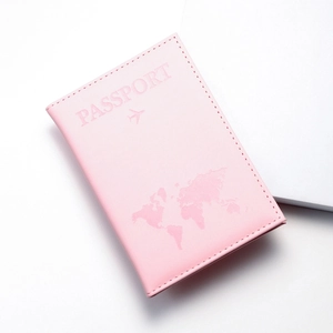 Detail shot of pink PU leather passport cover with world map embossed pattern