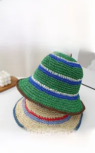 Detail of handmade striped straw hats showing crochet texture and color block patterns