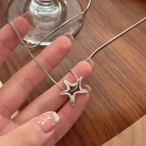 Silver starfish necklace with textured lava pendant on snake chain for women