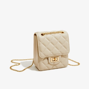 Detailed view of beige quilted PU leather crossbody bag with golden chain and twist-lock