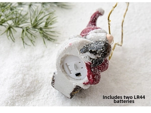 Detail view of the battery compartment and switch on the Christmas resin Santa figurine