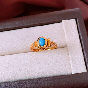 Detailed macro view of vintage oval turquoise ring with cubic zirconia in gold plating