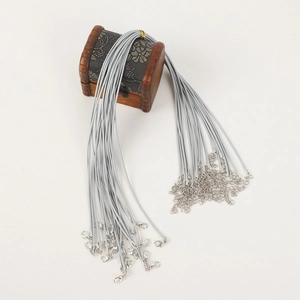 Gray leather necklace cords with silver lobster clasps on a decorative wooden box