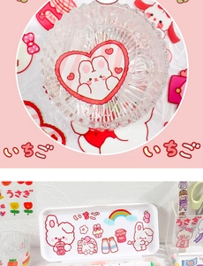 Detail of cute rabbit and strawberry stickers on a transparent ribbed glass bowl and box