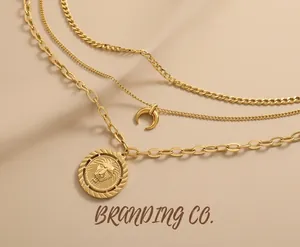 Close-up of layered 18K gold-plated necklaces with moon and lion head coin pendants