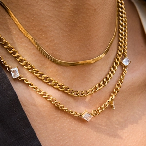 Layered gold titanium steel necklace featuring snake chain and cubic zirconia accents