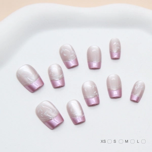 Handmade lilac purple French press-on nails with white leaf design on ceramic plate