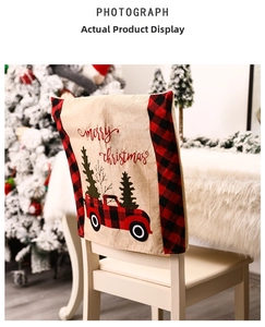 Close-up of burlap Christmas chair cover with red tractor and Merry Christmas print