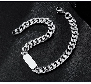 Macro shot of silver titanium steel Cuban chain bracelet with rectangular blank tag bar