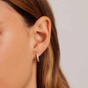 Close-up of S925 sterling silver wave earrings with double row diamonds on earlobe