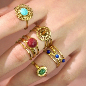 Macro shot of Bohemian gold plated rings featuring colorful natural stones for stacking