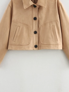 Detail of tan suede cropped jacket showing lapel collar and large black buttons