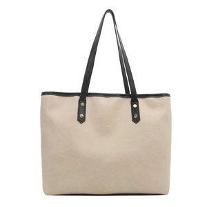 Beige oversized PU leather tote bag with black shoulder straps and gold rivet accents