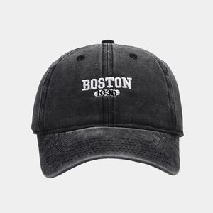 Detailed view of washed cotton baseball cap with white Boston 3D embroidery and vintage texture