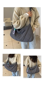 Detail of large quilted shoulder bag in charcoal grey with diamond pattern stitching