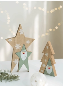 Close-up of wooden Christmas star and tree ornaments with festive snowflake details