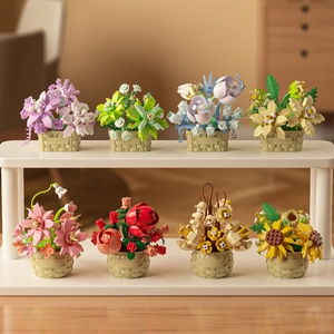 Set of 8 mini building block flower pots with roses and sunflowers on a white shelf