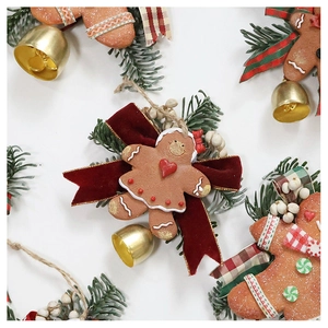 Detailed macro view of gingerbread man Christmas ornament with bells and pine needles
