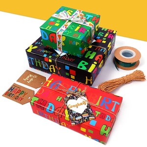 Colorful Happy Birthday gift wrapping paper set with ribbons, twine and hang tags