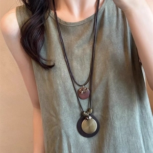 Retro long leather necklace featuring bronze metal bird and wooden disc pendant details