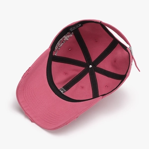 Inside view of pink cotton baseball cap with sweatband, wash label and metal buckle