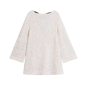 Detailed view of silver sequins and fabric texture on a long sleeve party dress