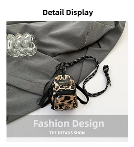 Close-up of leopard print mini bag with braided rope strap and gold-lettered fashion label