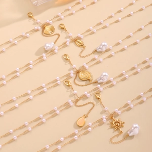 Elegant pearl body chain set featuring seashell and starfish pendants with lobster clasps
