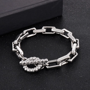 Gros plan du fermoir à bascule avec texture micro-perles sur un bracelet à maillons carrés