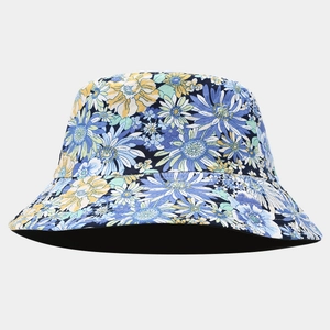 Close-up of vibrant daisy floral pattern on the wide brim of a reversible cotton bucket hat