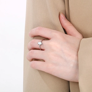 Macro view of silver ring featuring rectangular white opal and side diamond accents