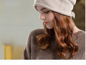 Detail of beige knit beanie with adjustable drawstring and soft wool texture