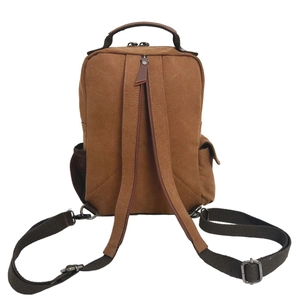 Brown canvas travel backpack featuring adjustable straps and mesh side pocket shown from back