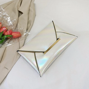 Detailed view of an iridescent white envelope clutch bag with gold metallic hardware accents