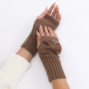 Detail of coffee brown cable knit fingerless gloves with a large bow on the wrist