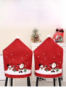 Detail of red Christmas chair covers with Santa and Snowman prints in a cozy room