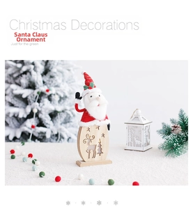 Detailed view of wooden Santa ornament with deer cutouts and festive tree decor