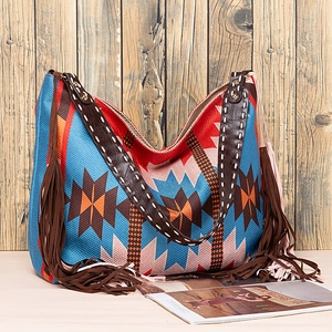 Detail of bohemian tote bag featuring ethnic patterns, brown tassels and contrast stitching