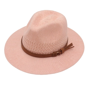 Pink woven straw hat with brown leather band and tassel detail for summer vacations