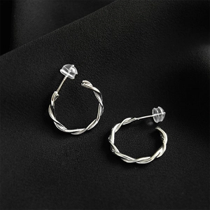 Polished S925 sterling silver twisted hoop earrings with clear silicone ear backings