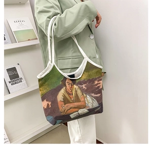 Artistic oil painting canvas tote bag styled as a shoulder bag on a female model