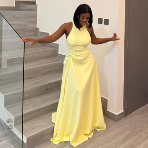 Detail of waist pleats and ruched design on this bright yellow satin maxi dress