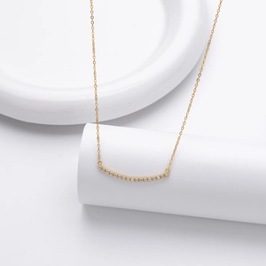 Vue détaillée du collier courbé en argent S925 doré avec micro-pavage de zircons étincelants
